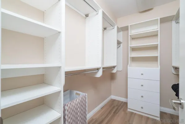a view of walk in closet with empty racks