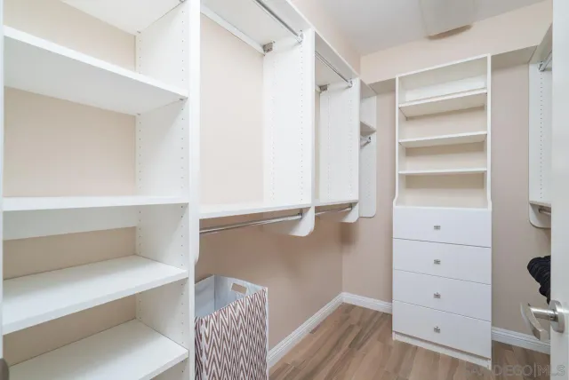 a view of walk in closet with empty racks