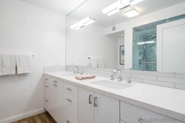 a bathroom with a sink a light fixture and a mirror