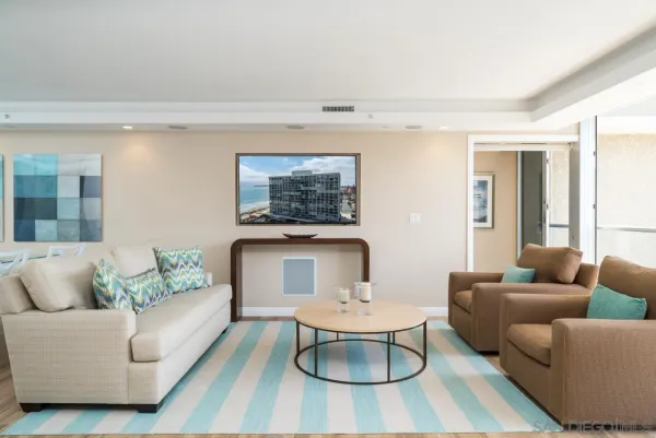 a living room with furniture and a potted plant