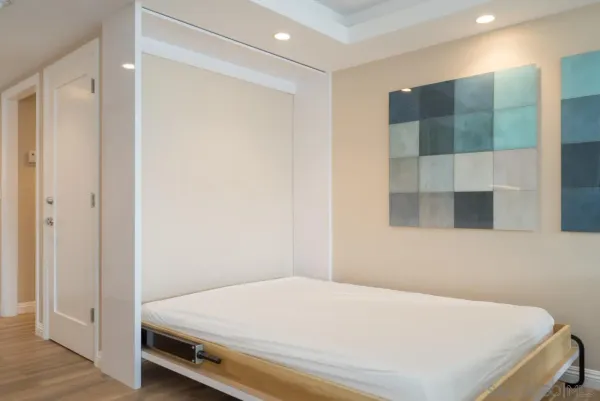 a bedroom with a bed and a mirror
