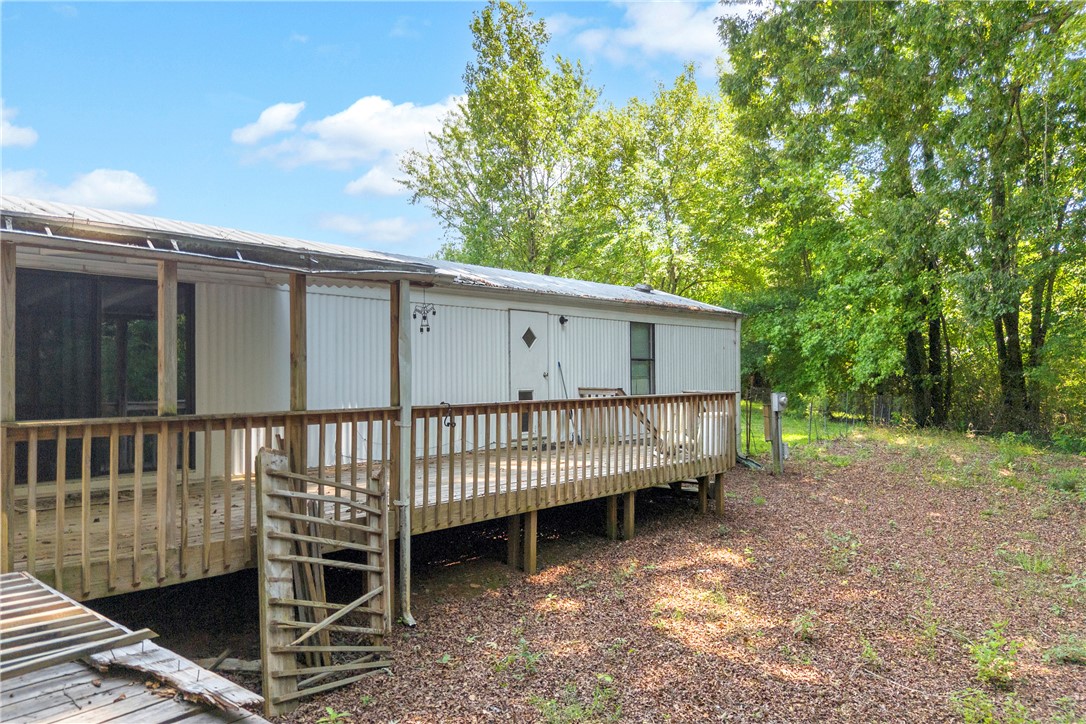 150 Newberry Road Walhalla, SC 29691 - Photo 25 of 47 A spacious wooden deck provides ample outdoor living space, nestled among mature trees.