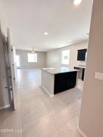 a large bathroom with a tub and granite countertop a sink