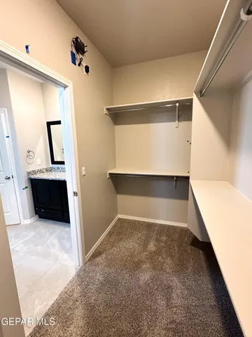 a view of a living room with a sink and mirror