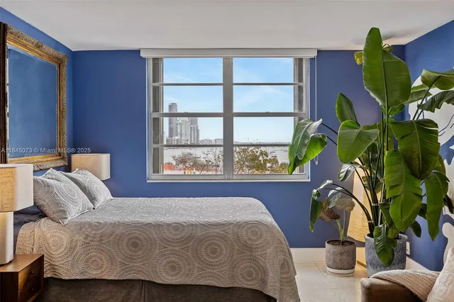 a bedroom with a bed and a potted plant