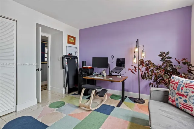 a living room with furniture a dining table and a potted plant