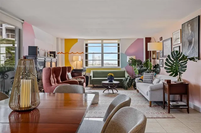 a living room with furniture fireplace and a large window