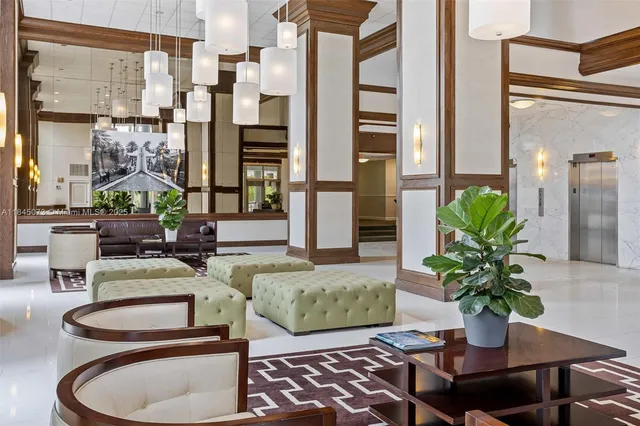 a living room with furniture flowerpot and wooden floor