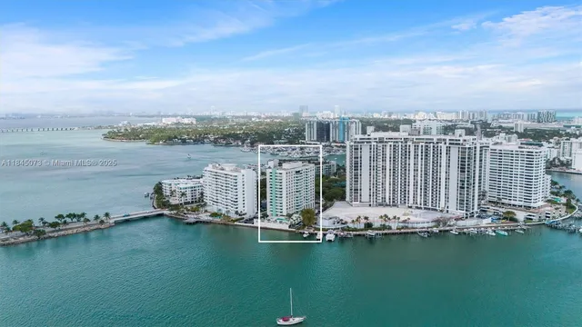 an ocean view with boat and palm trees