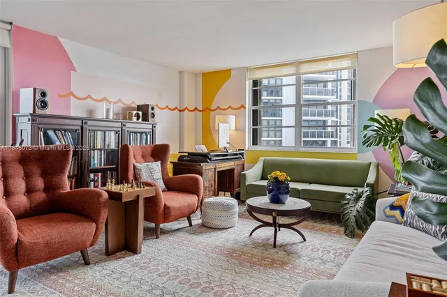 a living room with furniture fireplace and a large window