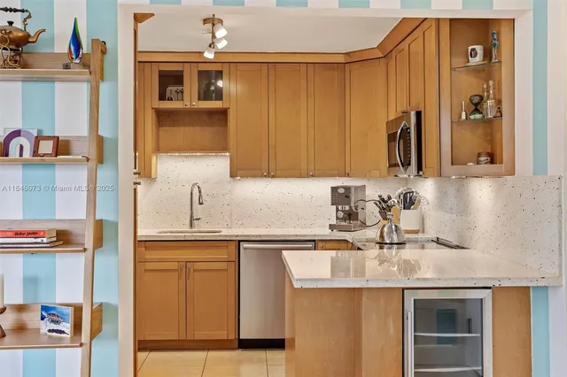 a kitchen with stainless steel appliances granite countertop a sink and cabinets
