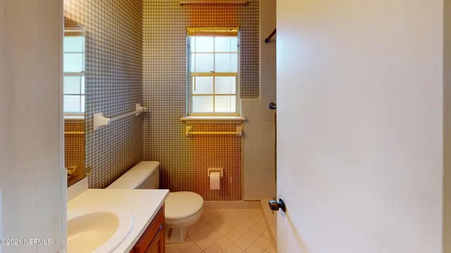 a kitchen with granite countertop a sink cabinets and stainless steel appliances