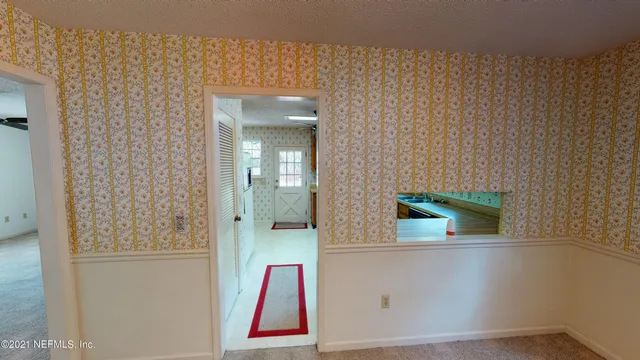 an empty room with windows and entrance