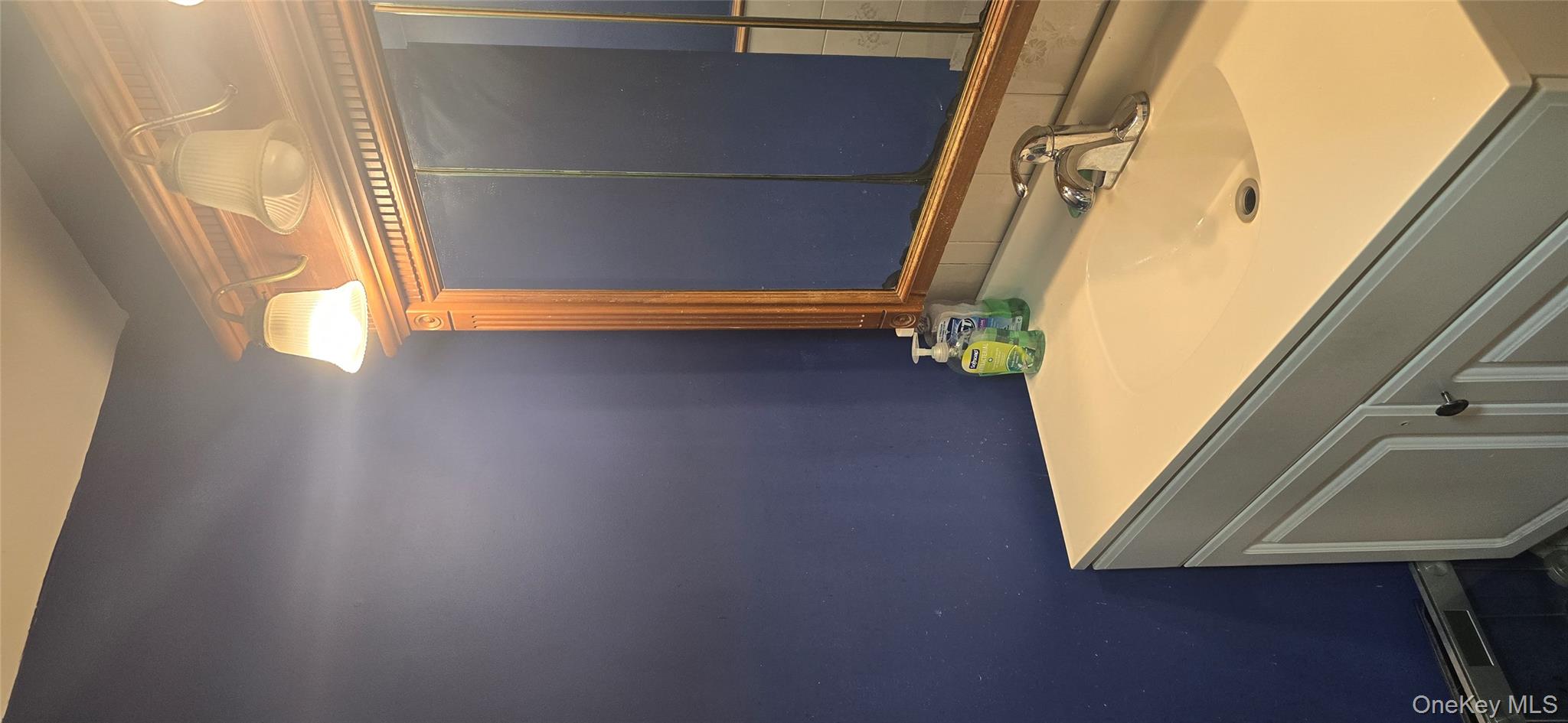 2 Ivy Road Mastic Beach, NY 11951 - Photo 13 of 25 a bathroom with a sink and a mirror