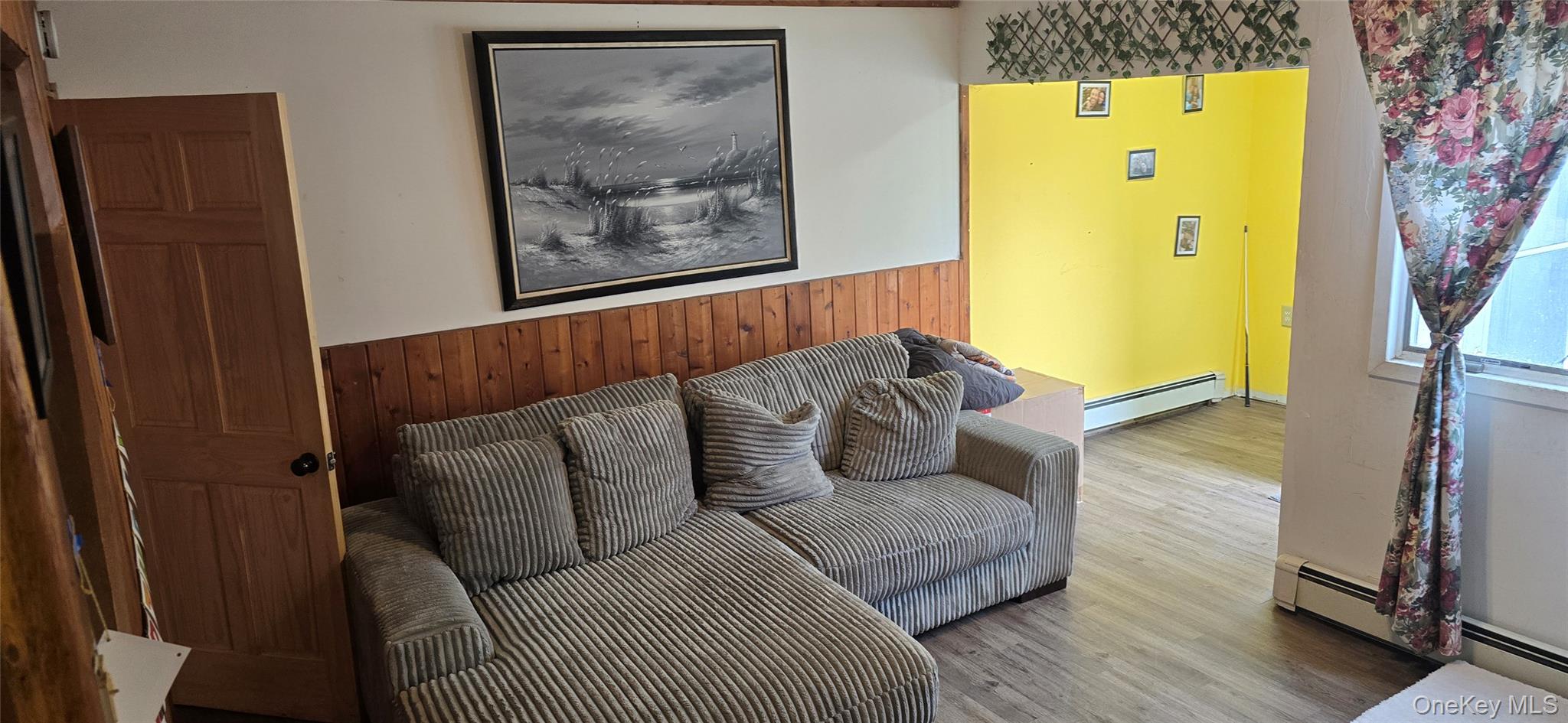 2 Ivy Road Mastic Beach, NY 11951 - Photo 3 of 25 a living room with a couch and a wooden floor
