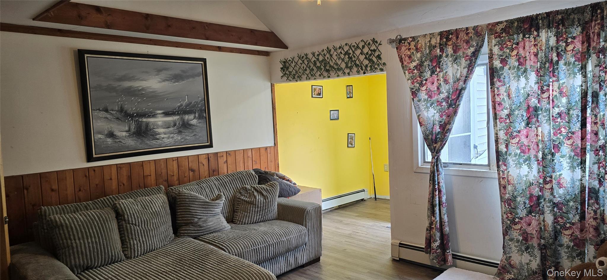 2 Ivy Road Mastic Beach, NY 11951 - Photo 6 of 25 a blue couch sitting in a living room next to a window