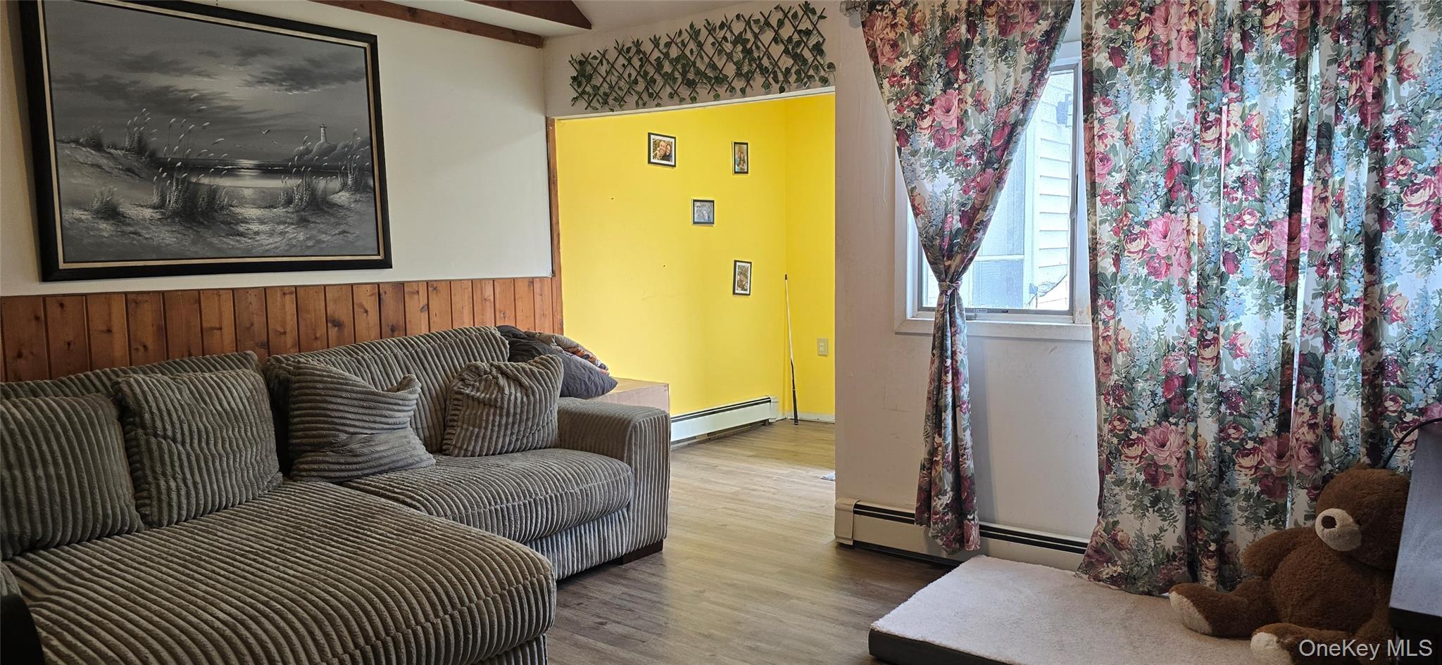 2 Ivy Road Mastic Beach, NY 11951 - Photo 7 of 25 a living room with a couch and a chandelier