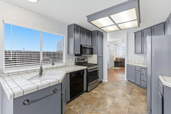 a kitchen with a sink stove and refrigerator