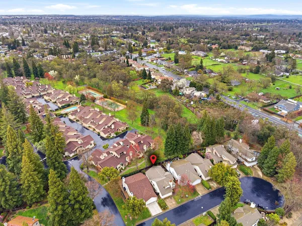 an aerial view of residential houses with outdoor space