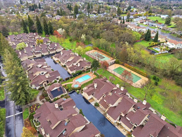 an aerial view of residential houses with outdoor space