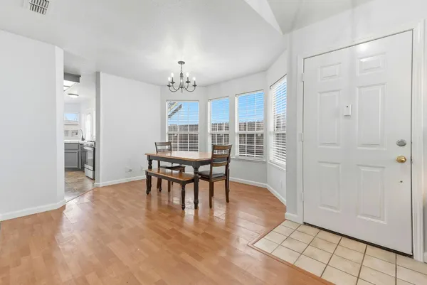 a view of a dining room with furniture and chandelier