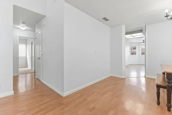 a view of a room with wooden floor and windows