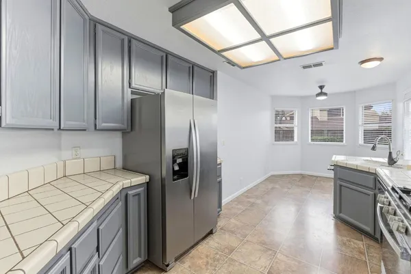 a kitchen with a sink stove and refrigerator