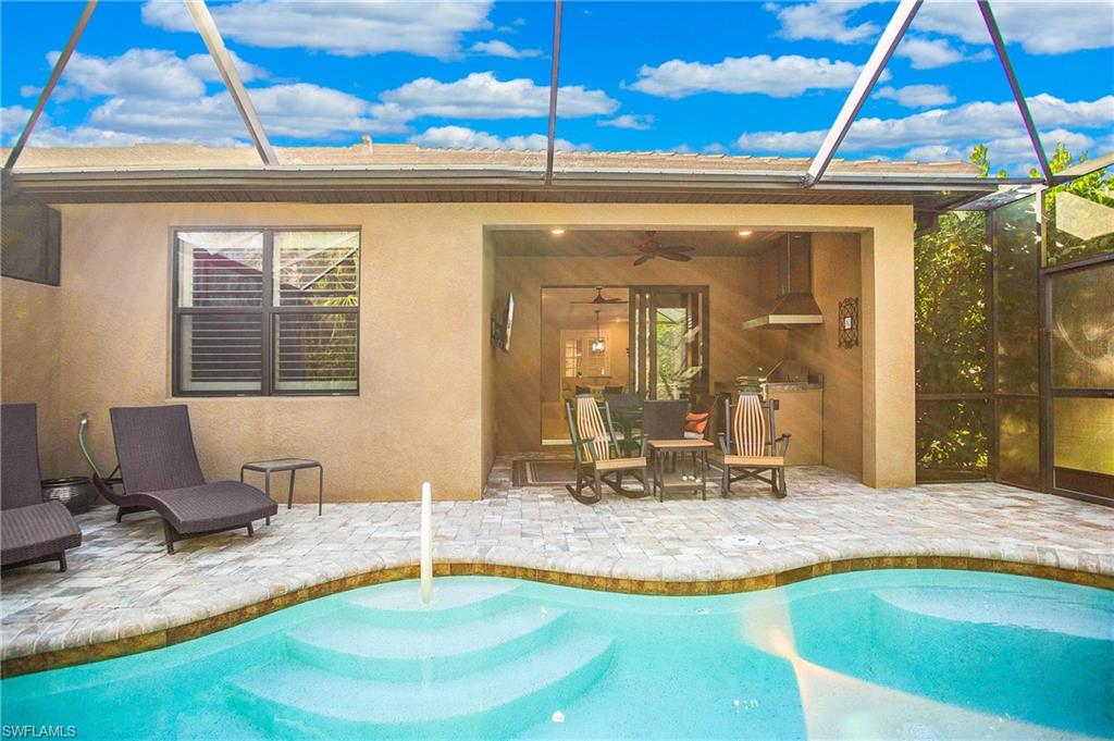 a swimming pool with lawn chairs