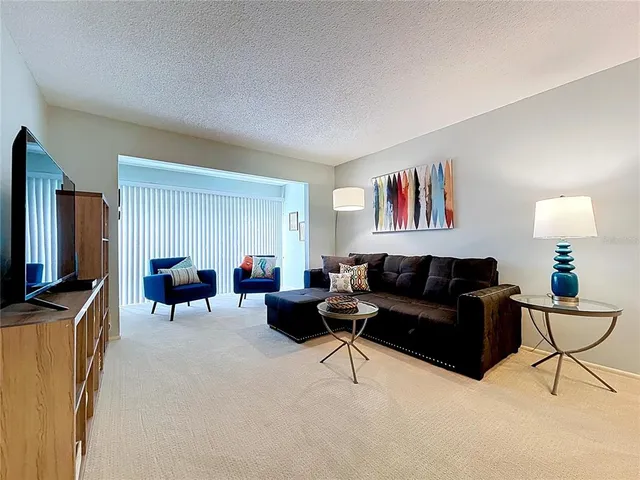 a living room with furniture and a lamp