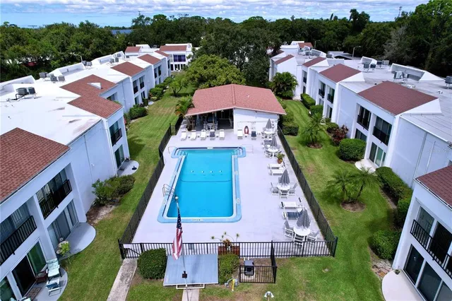 an aerial view of multiple houses with a yard