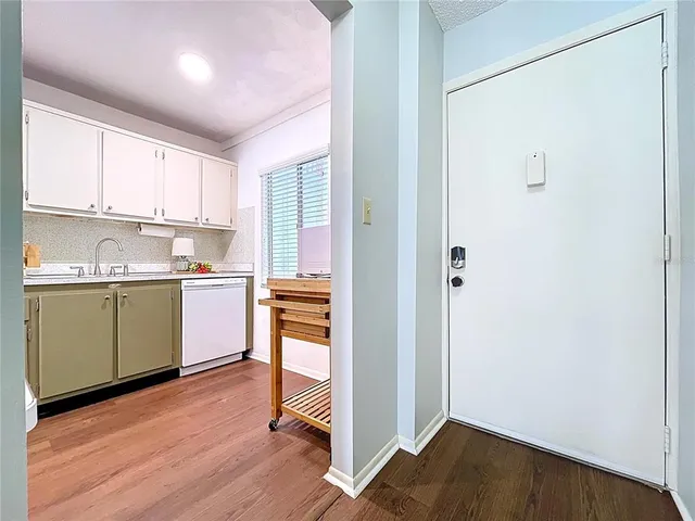 a kitchen with a sink cabinets and window