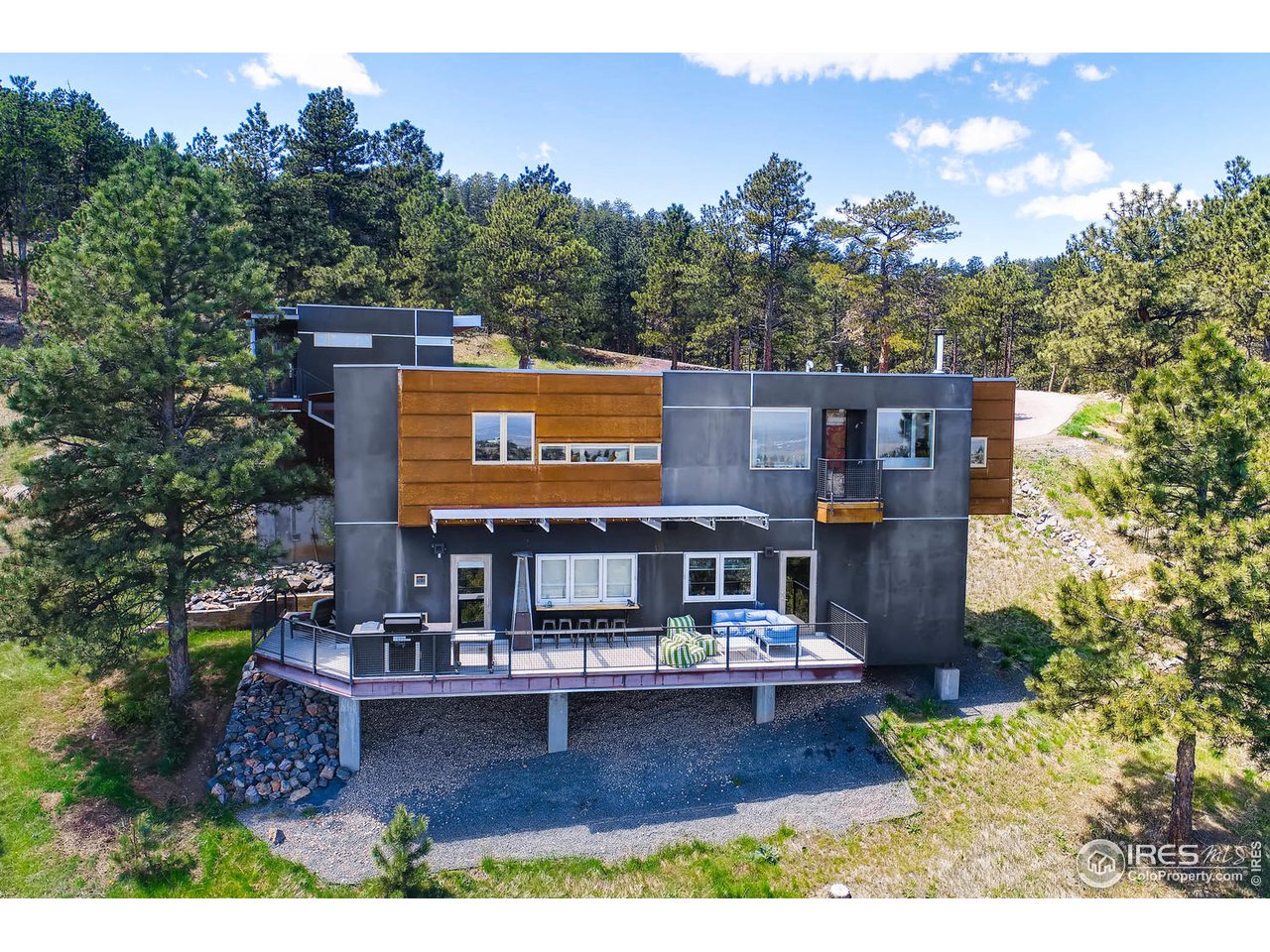 a view of a house with a garden and a sign board
