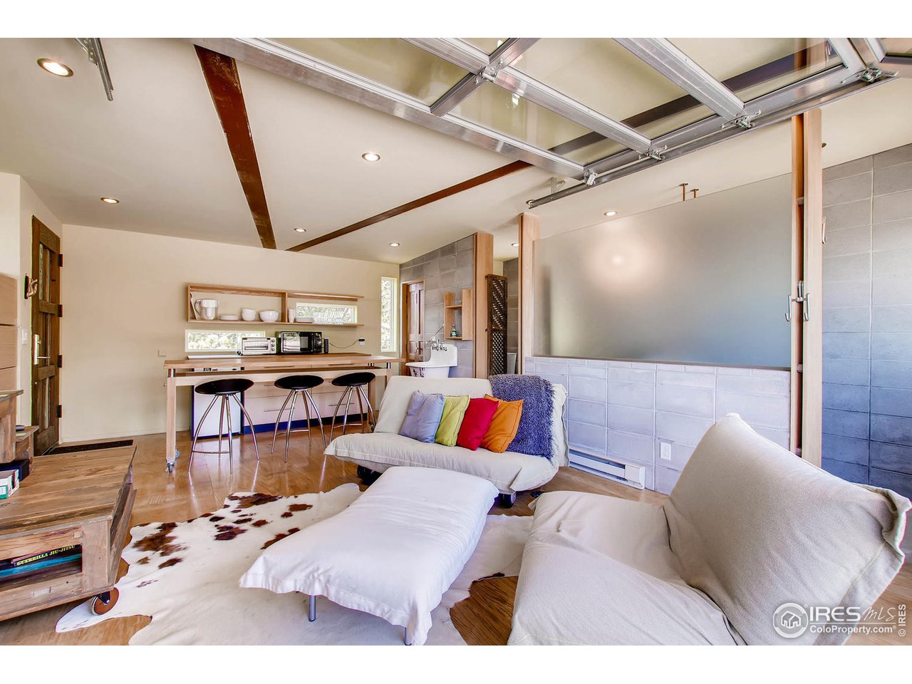 1440 Reed Ranch Road Boulder, CO 80302 - Photo 29 of 40 a living room with furniture and a flat screen tv