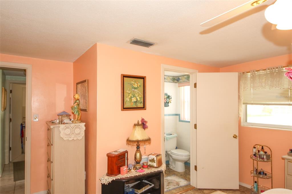 10638 Oak Hill Drive Port Richey, FL 34668 - Photo 12 of 29 a bathroom with a granite countertop toilet a sink and a mirror