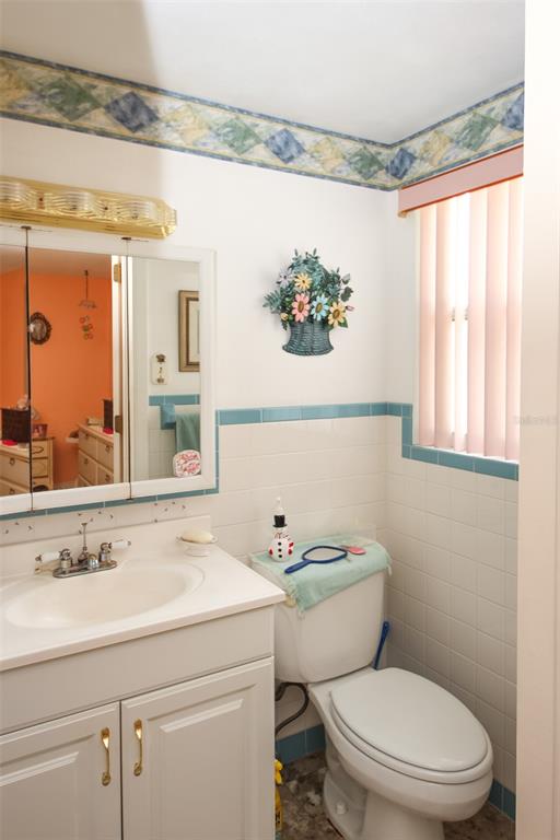 10638 Oak Hill Drive Port Richey, FL 34668 - Photo 14 of 29 a bathroom with a sink a toilet and a mirror