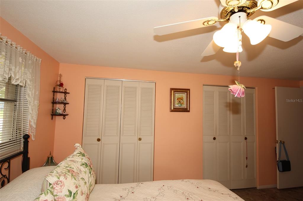 10638 Oak Hill Drive Port Richey, FL 34668 - Photo 16 of 29 a bedroom with a bed and a chandelier