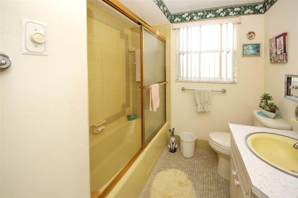 10638 Oak Hill Drive Port Richey, FL 34668 - Photo 18 of 29 a bathroom with a granite countertop toilet sink and mirror
