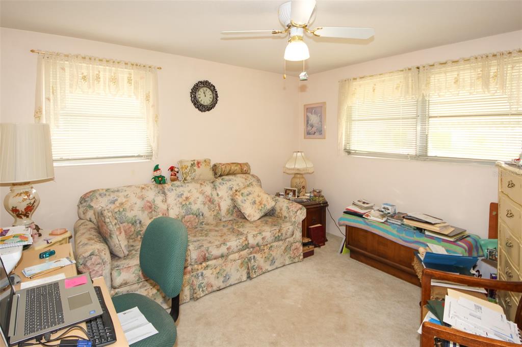 10638 Oak Hill Drive Port Richey, FL 34668 - Photo 19 of 29 a bedroom with bed and a window