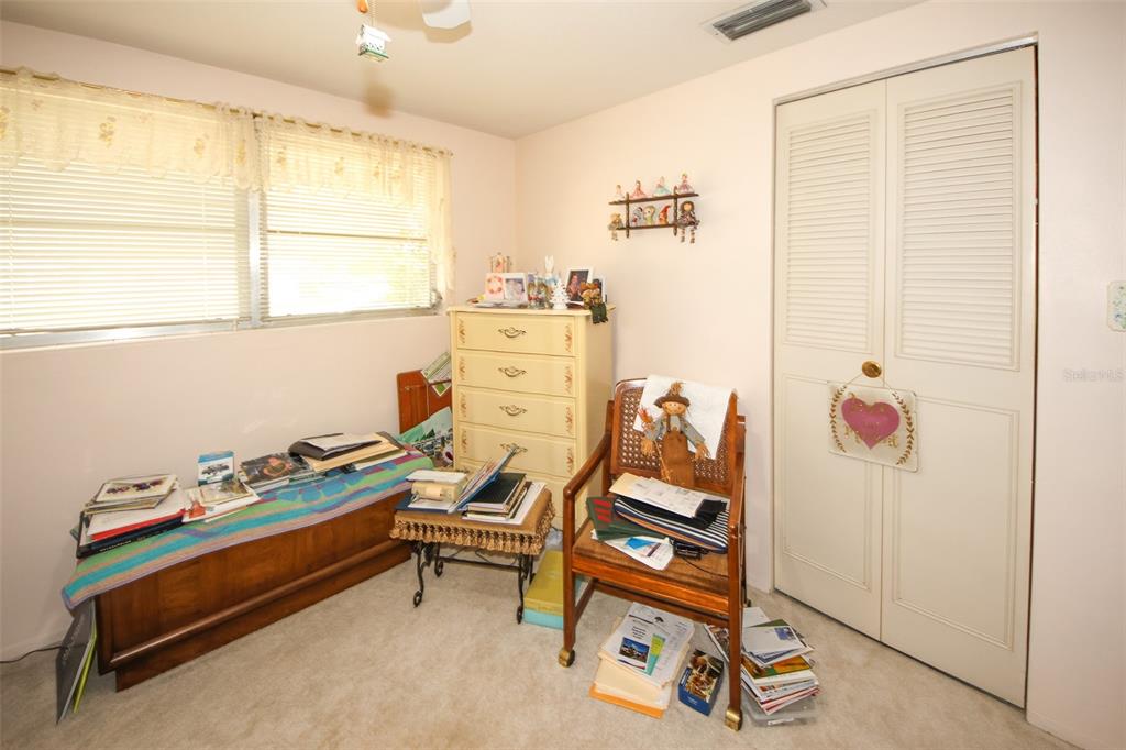 10638 Oak Hill Drive Port Richey, FL 34668 - Photo 20 of 29 a bedroom with furniture and a window