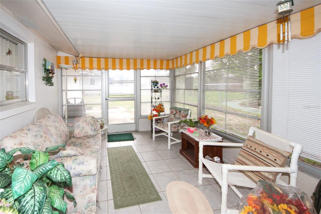 10638 Oak Hill Drive Port Richey, FL 34668 - Photo 21 of 29 a living room filled with furniture and a large window
