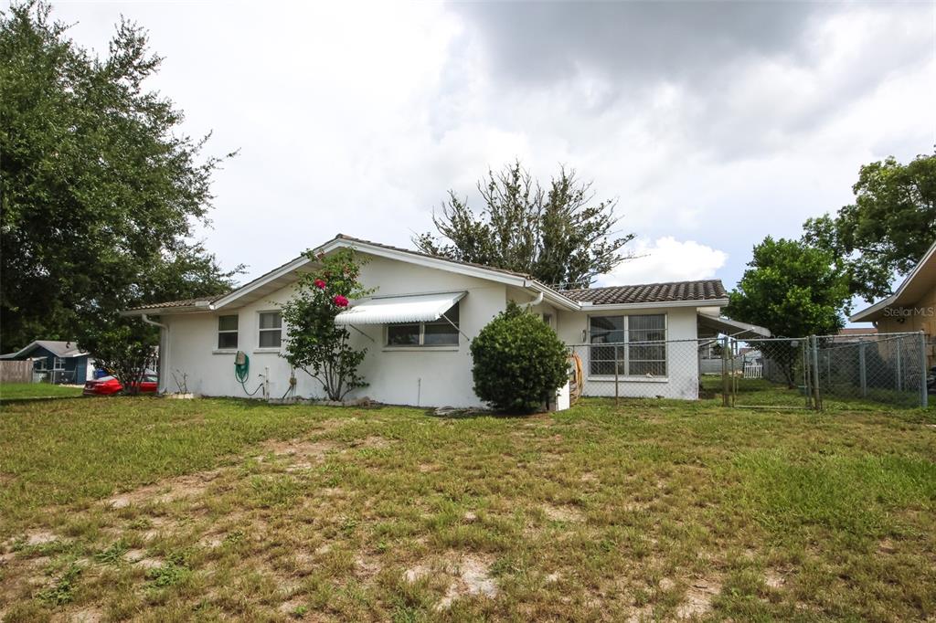 10638 Oak Hill Drive Port Richey, FL 34668 - Photo 26 of 29 a view of a house with a yard