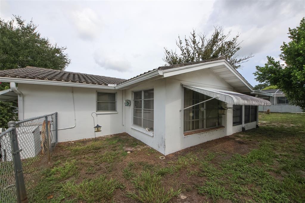 10638 Oak Hill Drive Port Richey, FL 34668 - Photo 27 of 29 a front view of a house with a yard