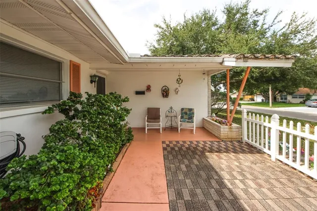 a view of a patio with table and chairs potted plants with wooden floor