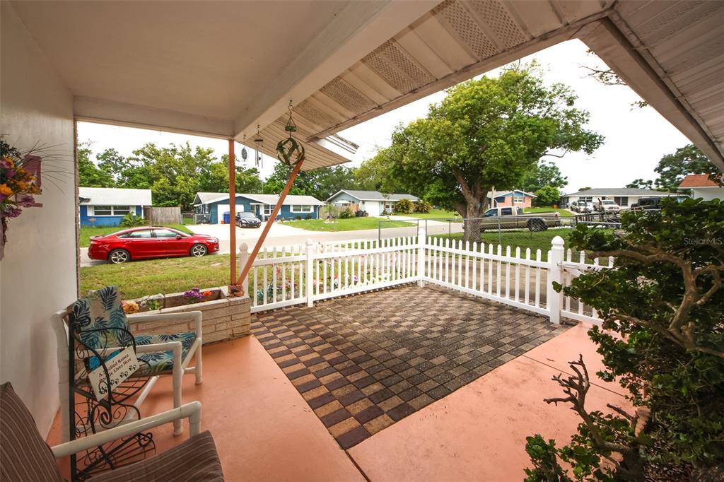 10638 Oak Hill Drive Port Richey, FL 34668 - Photo 5 of 29 a view of a porch with wooden floor barbeque oven and outdoor seating