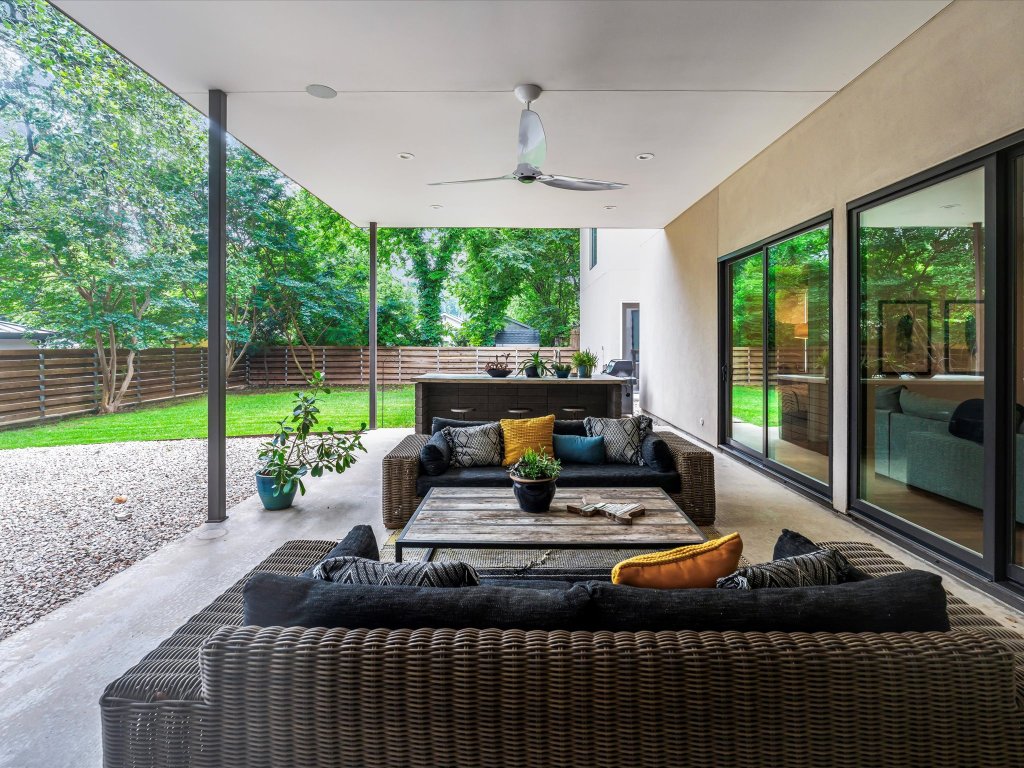 1703 Dexter Street Austin, TX 78704 - Photo 21 of 34 Fenced backyard featuring an outdoor hangout area, a ceiling fan, and a patio area