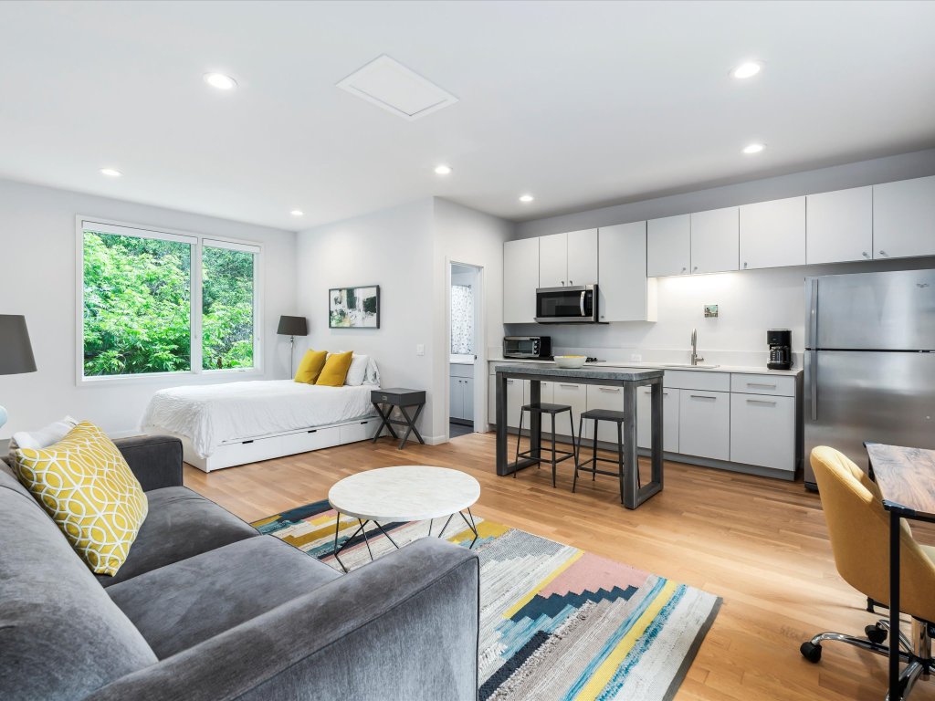 1703 Dexter Street Austin, TX 78704 - Photo 32 of 34 Bedroom featuring freestanding refrigerator, light wood finished floors, and recessed lighting