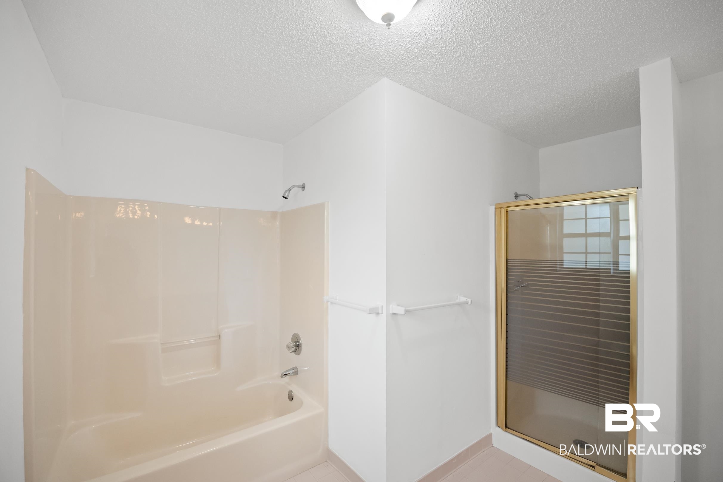 2673 Pine Ridge Drive Lillian, AL 36549 - Photo 17 of 38 Bathroom with a textured ceiling and shower / bath combination