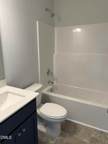 a bathroom with a toilet a sink and bathtub