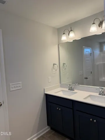 a bathroom with a sink vanity and a mirror