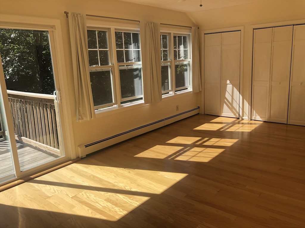 46 Auburndale Avenue, Unit 46 Newton, MA 02465 - Photo 11 of 17 a view of a living room with a balcony and floor to ceiling windows